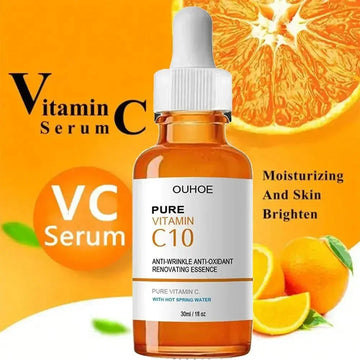 Brown dropper bottle of vitamin C serum with white cap, orange background and citrus fruits.