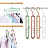 Multi-slot plastic clothes hangers in pastel colors, organizing shirts for space-saving storage.