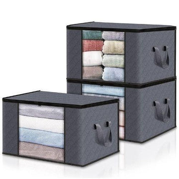 Set of gray fabric storage bins with handles, filled with folded towels and clothes.