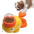 Puppy using yellow and orange interactive duck-shaped pet food dispenser toy