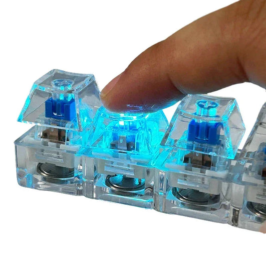Close-up of finger pressing a transparent blue mechanical keyboard switch with LED backlight.
