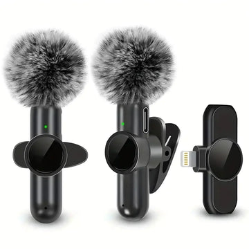 Wireless clip-on microphones with gray furry windshields and black charging adapter