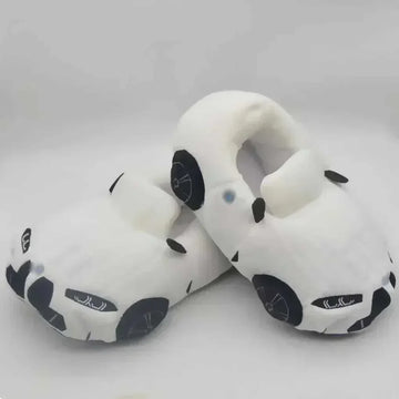 Plush white slippers shaped like cars, soft material, closed-toe, cozy fit.