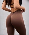Brown high-waisted ribbed leggings with sculpting fit, paired with black strappy top