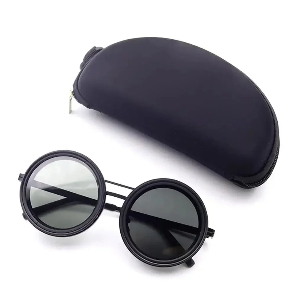 Round black sunglasses with dark lenses and hard protective case on white background