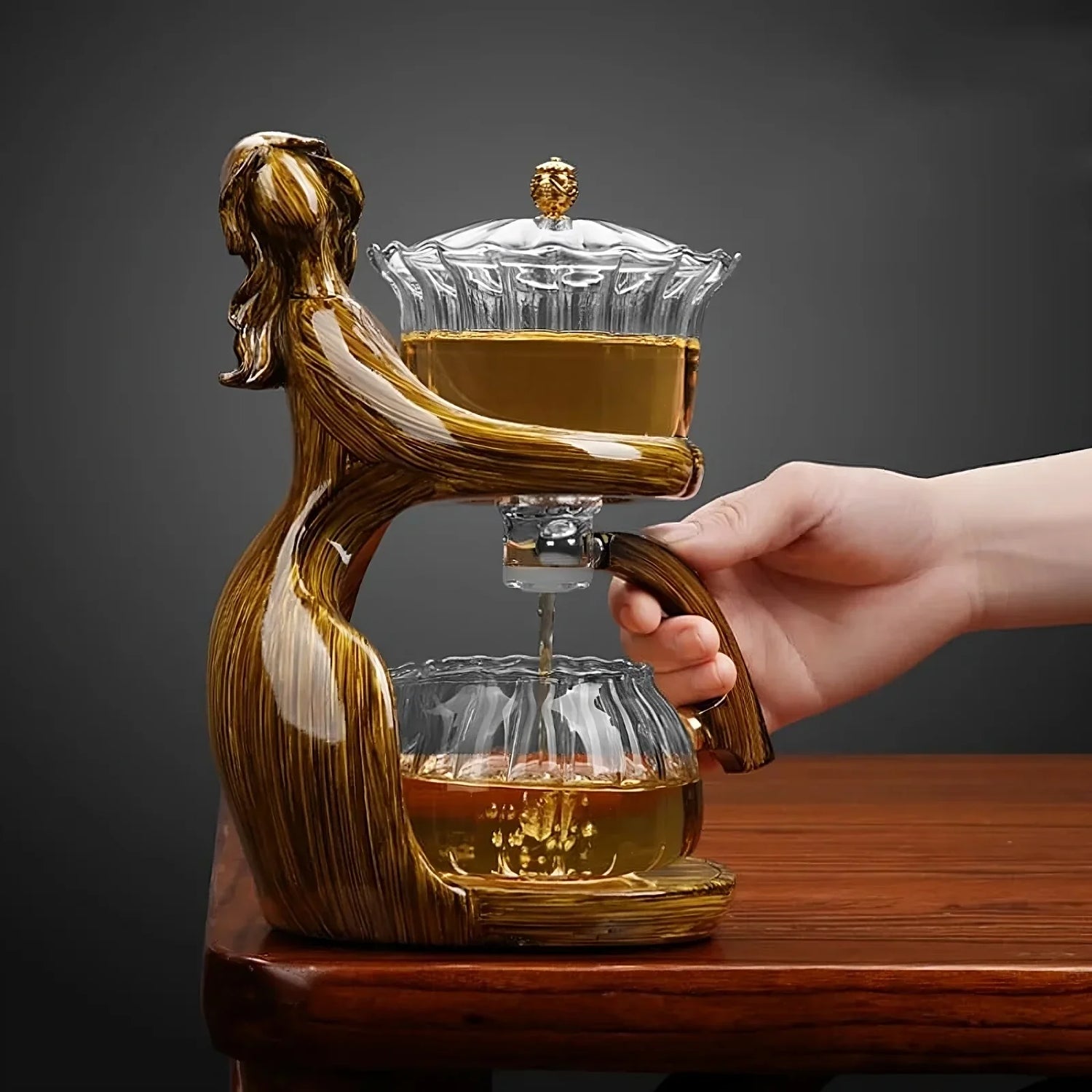 Elegant glass and resin tea pot set with human figure design, modern home decor.
