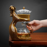 Elegant glass and resin tea pot set with human figure design, modern home decor.