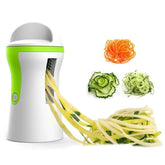 Electric vegetable spiralizer making zucchini noodles, with julienned carrots, cucumbers, and squash