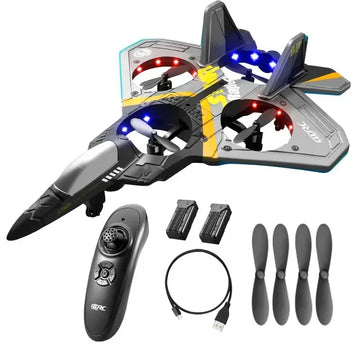 Futuristic black and gray remote control jet drone with LED lights, controller, batteries, USB cable, and extra propellers.