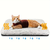 Cat in a textured maroon sweater on a white sherpa fleece heating pad, relaxed fit.