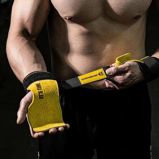 Man wearing yellow and black padded lifting gloves with adjustable wrist straps, athletic fit