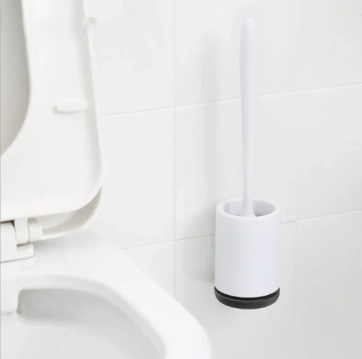 Minimalist white plastic toilet brush set with holder mounted on bathroom wall