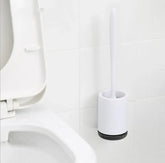 Minimalist white plastic toilet brush set with holder mounted on bathroom wall