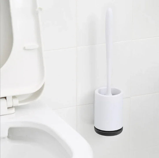 Minimalist white plastic toilet brush set with holder mounted on bathroom wall