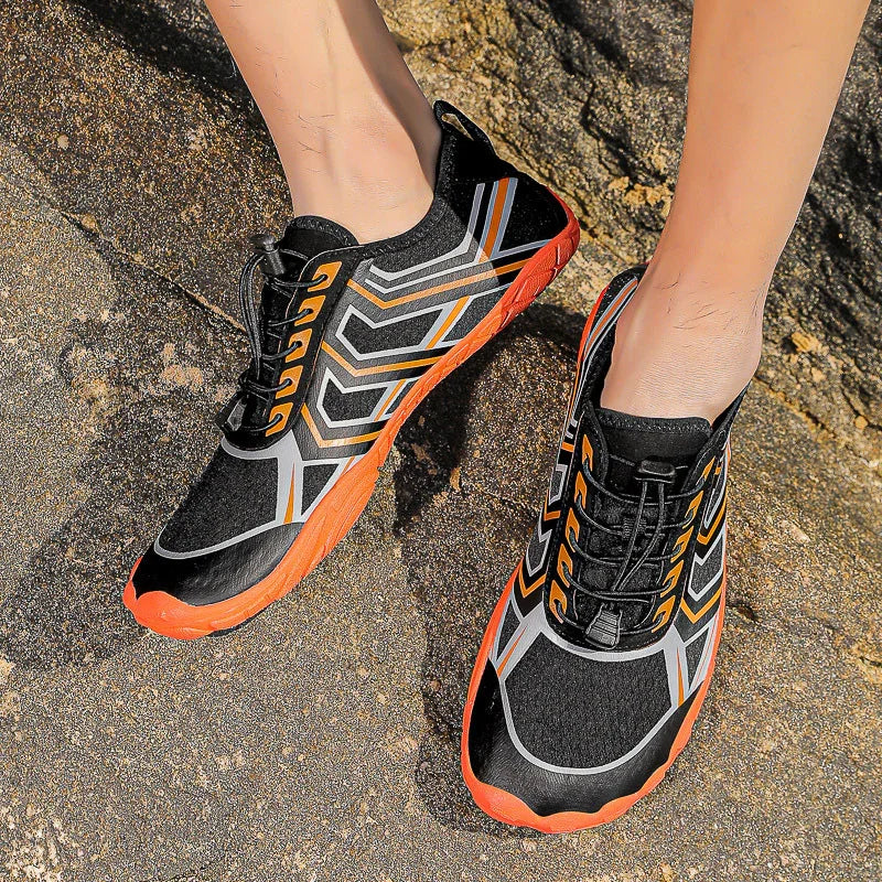 Black and orange athletic sneakers with geometric patterns, lightweight mesh material, slim fit