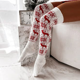 White knit over-the-knee socks with red reindeer and snowflake pattern, cozy winter style