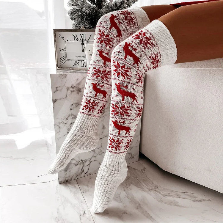 White knit over-the-knee socks with red reindeer and snowflake pattern, cozy winter style