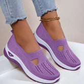 Lavender slip-on knit sneakers with breathable mesh, white soles, and casual fit.