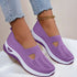 Lavender slip-on knit sneakers with breathable mesh, white soles, and casual fit.