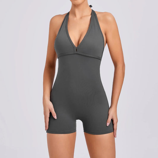 Dark gray halter neck romper with fitted stretch material and deep V neckline
