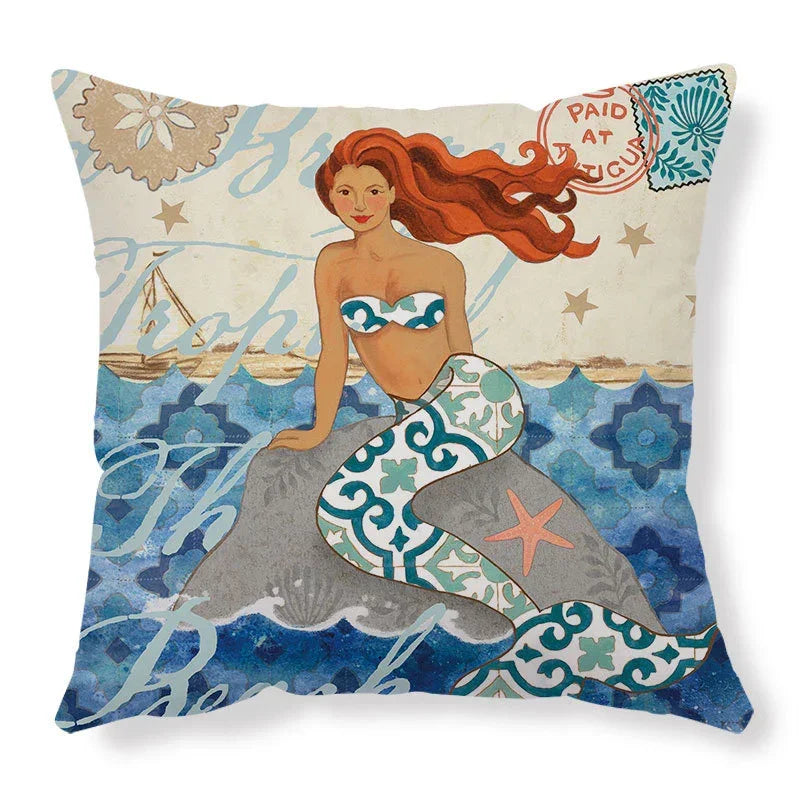 Decorative pillow with a colorful mermaid illustration, blue patterned tail, and ocean background.