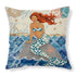 Decorative pillow with a colorful mermaid illustration, blue patterned tail, and ocean background.