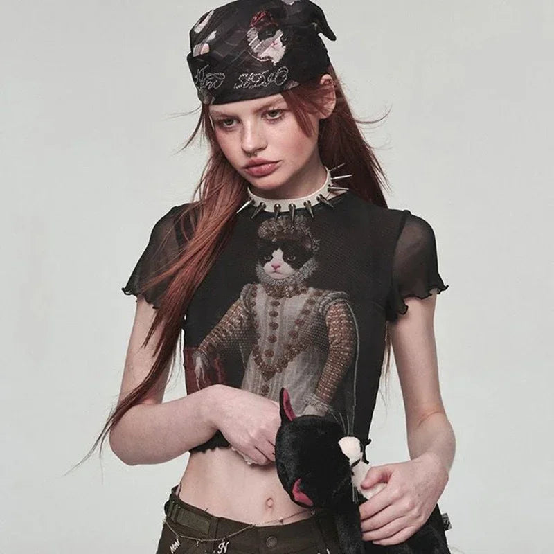 Sheer black mesh crop top with royal cat graphic, edgy punk fit, paired with printed bandana.
