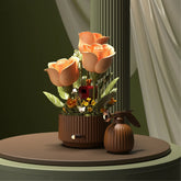 Artificial peach rose bouquet in ribbed brown pot with matching spray bottle on round table