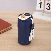Matte navy blue insulated travel mug with digital temperature display and white carrying strap