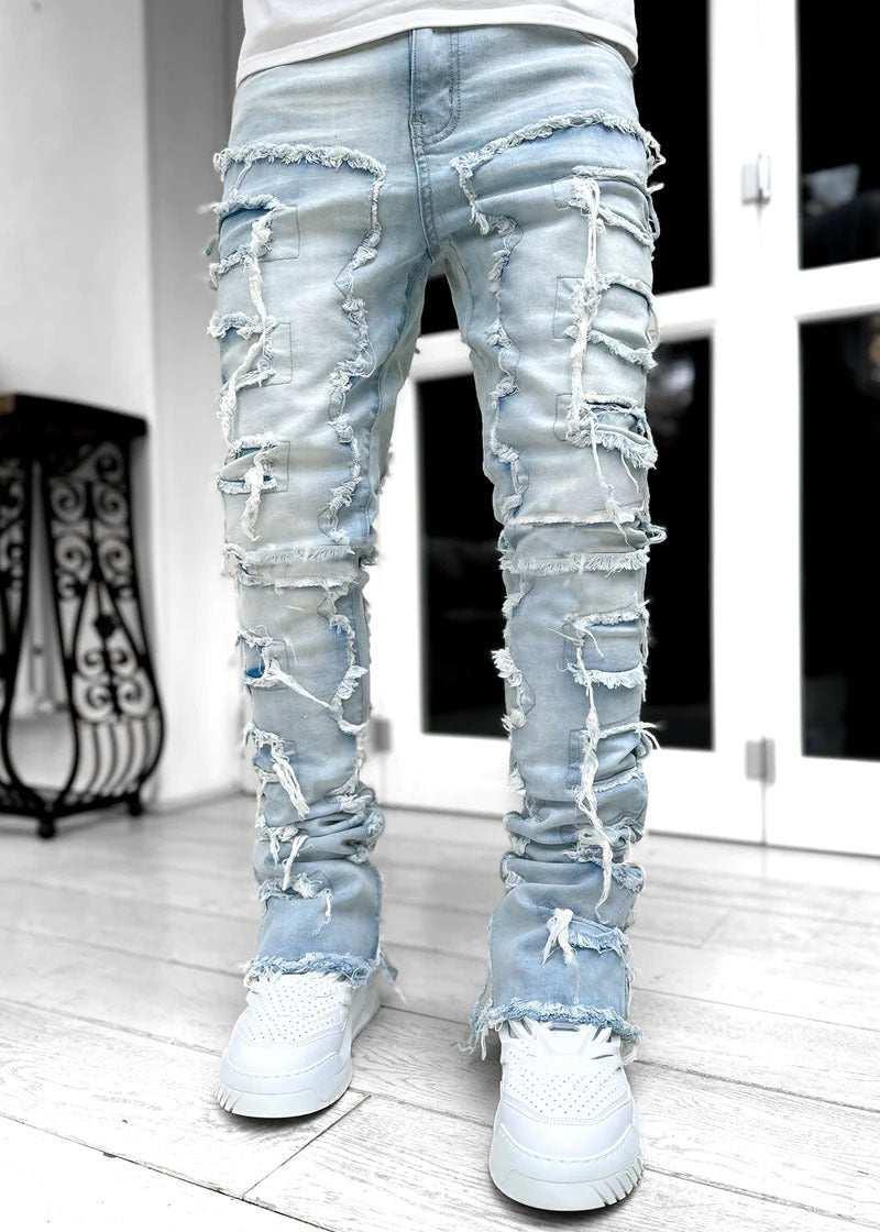 Light wash skinny jeans with heavy distressed detailing and frayed edges, streetwear style.
