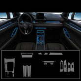 Black car interior with blue accent trim, leather seats, modern dashboard and control panels.