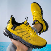 Yellow mesh athletic sneakers with black sole, sporty design, and snug fit