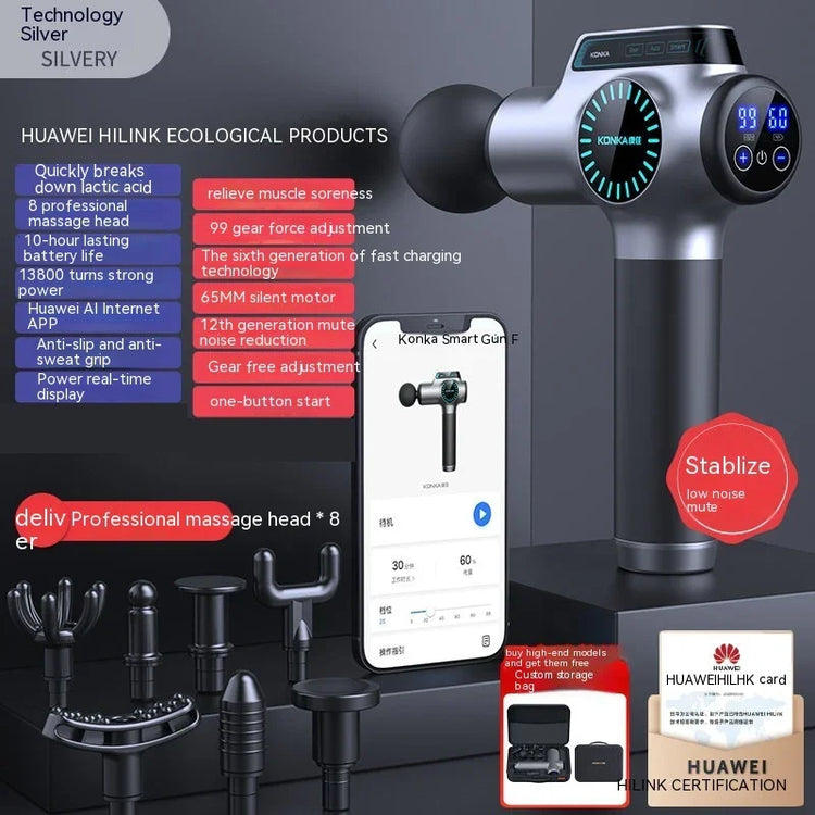 Silver massage gun with digital display, multiple black massage heads, modern tech accessories