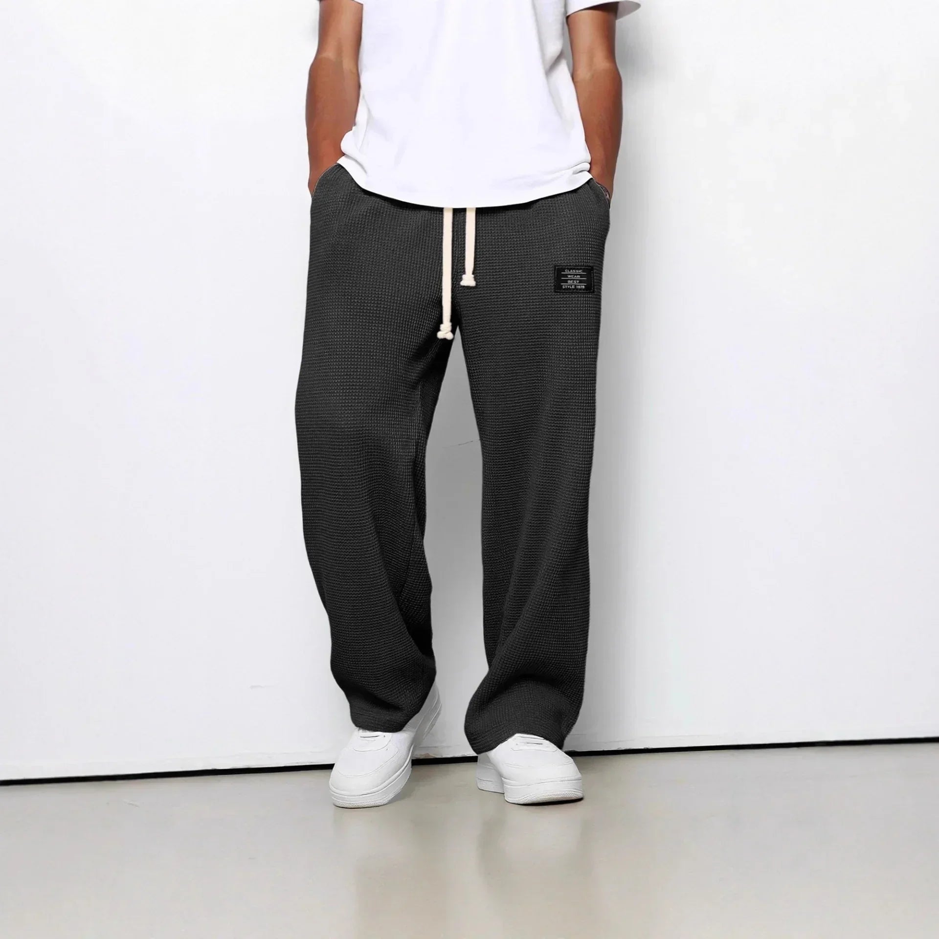 Relaxed fit charcoal textured waffle knit pants with drawstring waist and patch detail