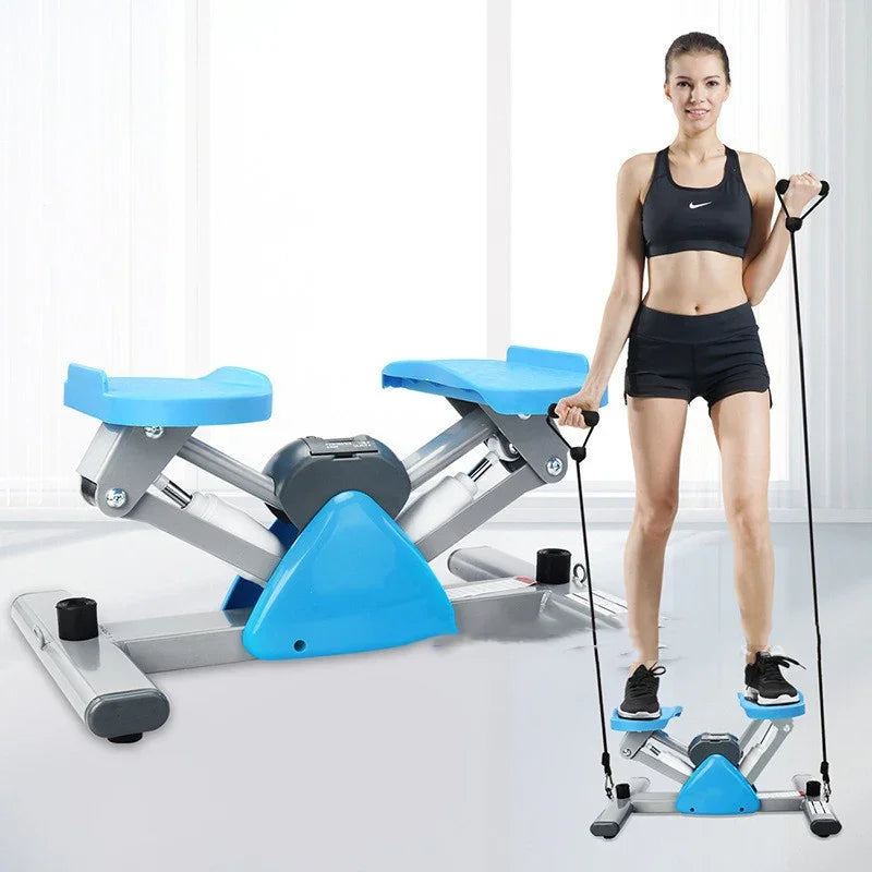 Woman wearing black athletic crop top and shorts using a blue at-home stepper exercise machine