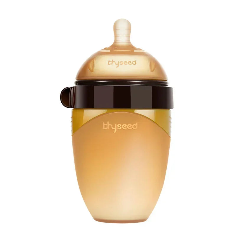 Translucent amber silicone baby bottle with wide neck and soft nipple, brown lid