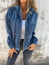Woman wearing a loose-fit blue corduroy jacket with zipper, white tank top, and black jeans