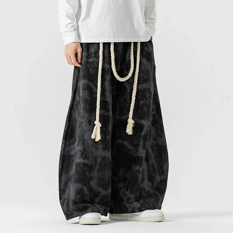Loose fit black tie-dye wide leg pants with white rope belt, streetwear style