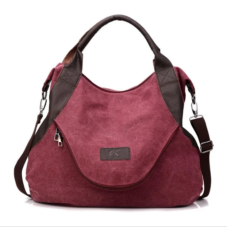 Burgundy canvas shoulder bag with brown faux leather accents and adjustable strap