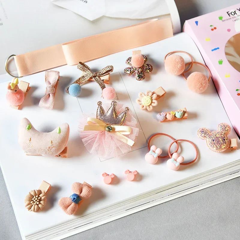 Set of pastel pink and gold hair accessories with bows, flowers, and plush shapes on white background