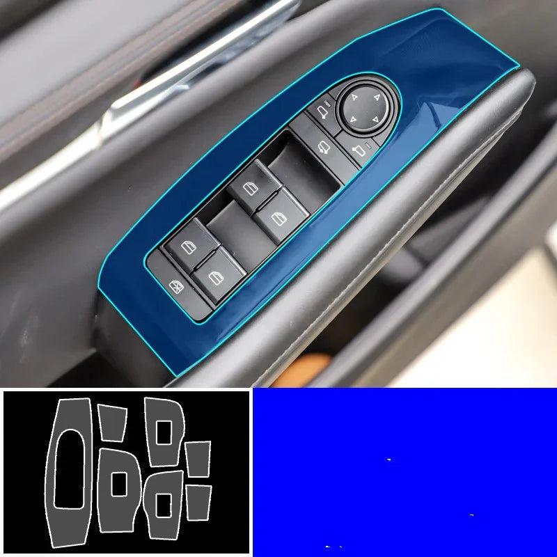 Blue glossy car window switch panel cover on black door interior, close-up view