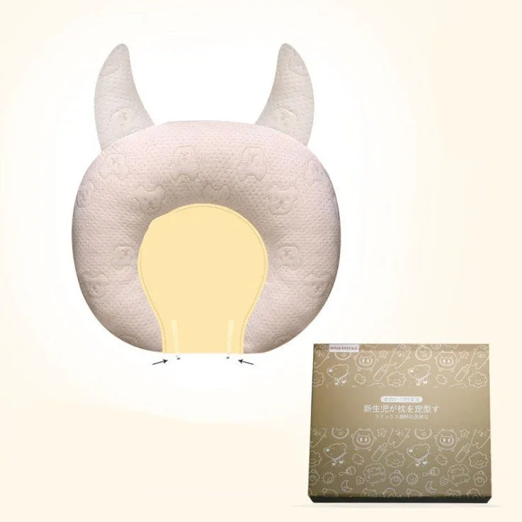Soft beige ergonomic neck pillow with horn accents, plush texture, and contour fit design