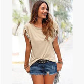 Woman wearing beige fringe sleeve top and denim shorts, casual summer streetwear style