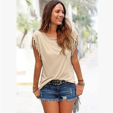 Woman wearing beige fringe sleeve top and denim shorts, casual summer streetwear style