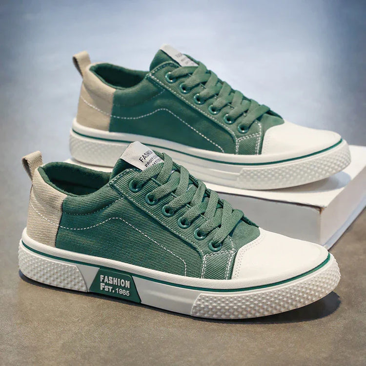 Green and beige canvas sneakers with white rubber soles, lace-up style, casual streetwear fit