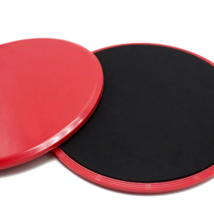 Pair of round red and black plastic fitness sliders on a white background