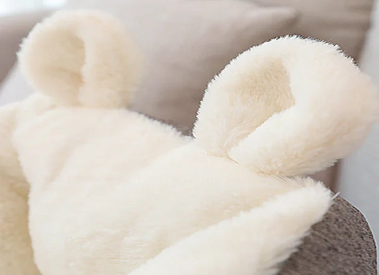 Cream-colored faux fur hoodie with bear ear details, plush soft material, relaxed fit