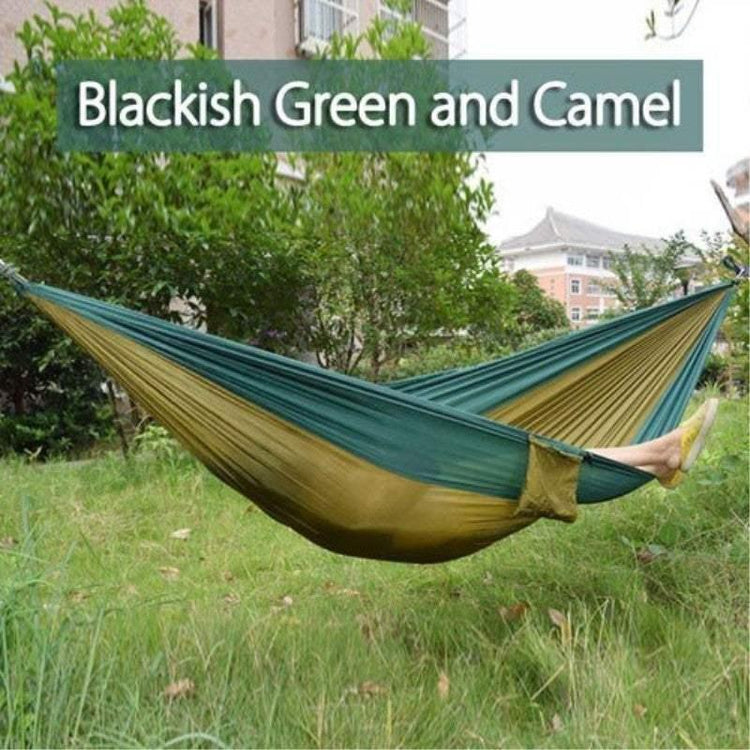Outdoor hammock in blackish green and camel, lightweight nylon, relaxed fit, garden setting