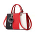 Colorblock handbag with red, black, and white panels, faux leather, gold hardware, and pompom charm