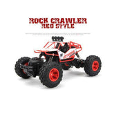 Red and white remote control rock crawler truck with large off-road tires on white background